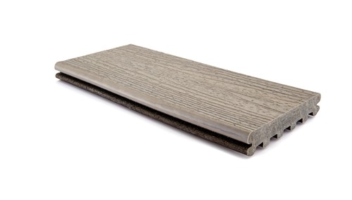 A profile view of a composite board. The board is a gray color and the pattern on the surface closey resembles wood.