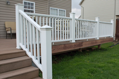 White PVC railing with brown composite decking.
