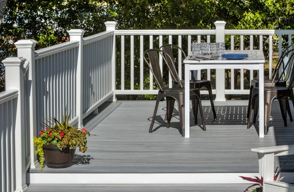 White Deck Railing With Patio Table And Metal Chairs
