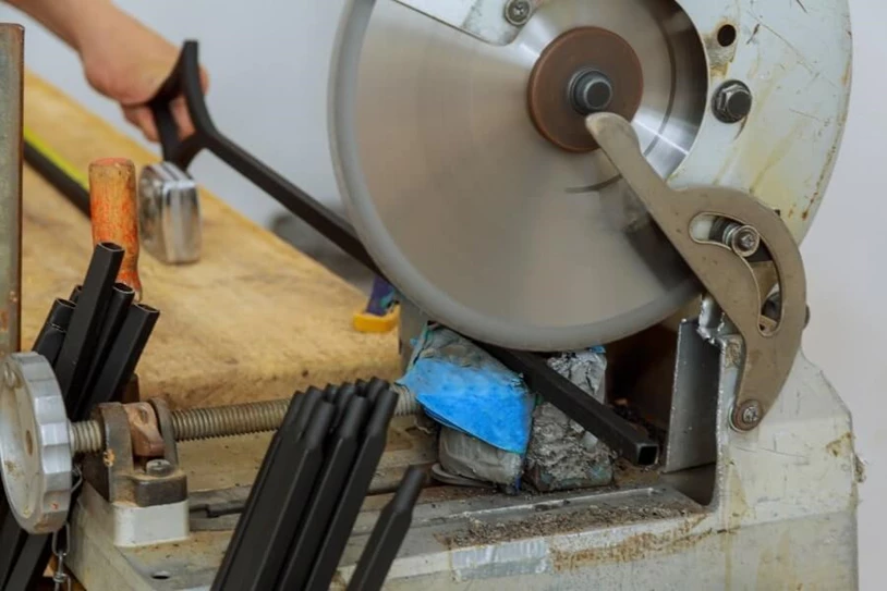 Chop saw cutting through metal railing