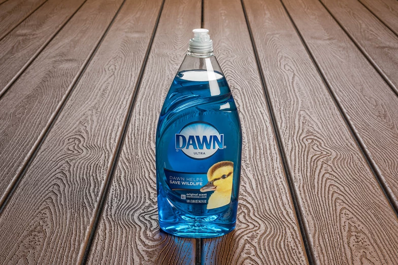 A bottle of Dawn Soap on a deck.