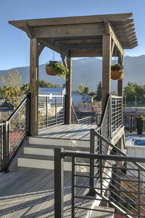 A walkway dividing a large yard with a pergola over the walkway