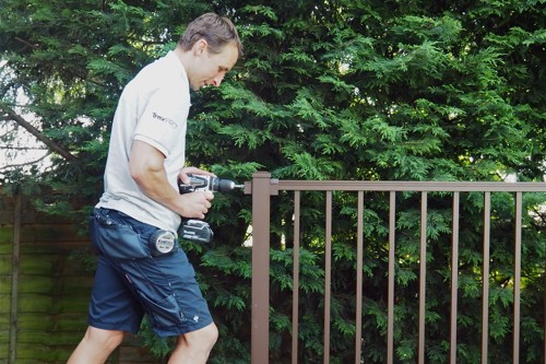 Contractor installing bronze colored Trex aluminum railing.