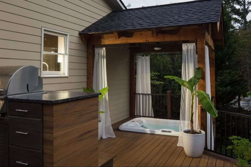 Patio with a hottub inclosed by a pergola
