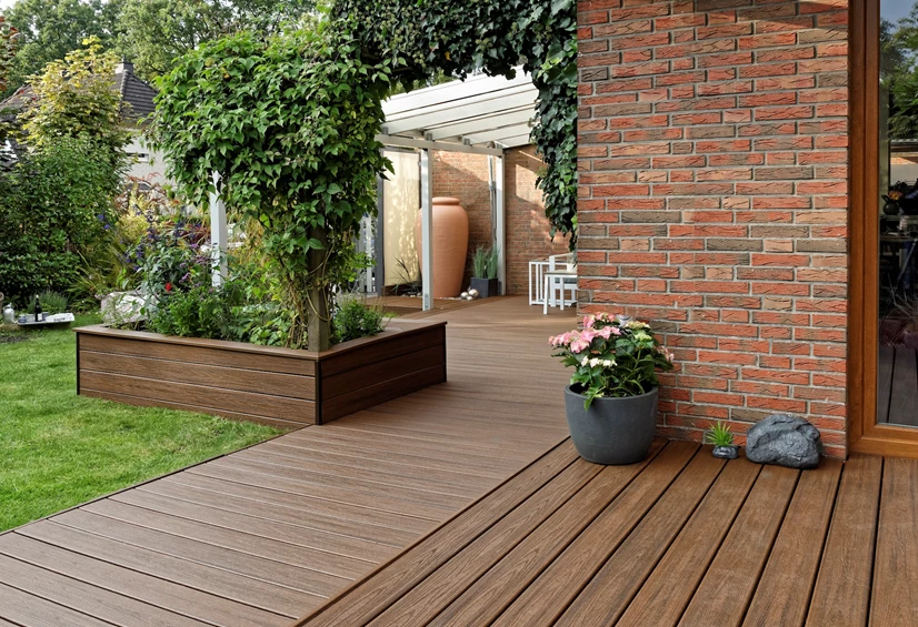 Big planter box with a large bush and other flowers