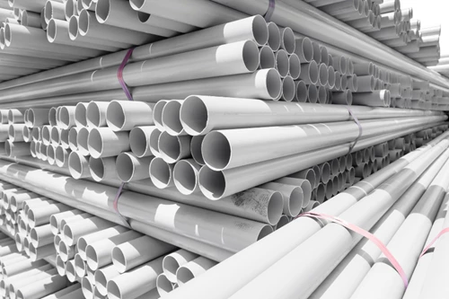 Warehouse of large stacks of PVC cylinders tied together in bundles of 10