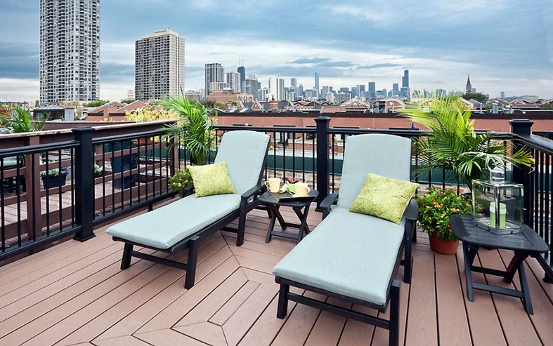 Roof top deck with 2 sunlounger chairs in an urban setting