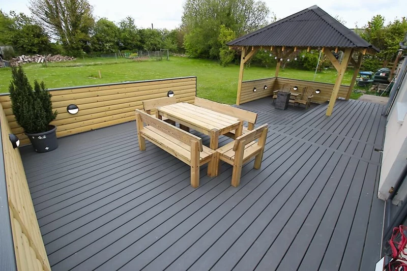 Dark grey Trex decking on a patio with a pergola