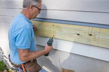 Use structural screws to attach the ledger to the house