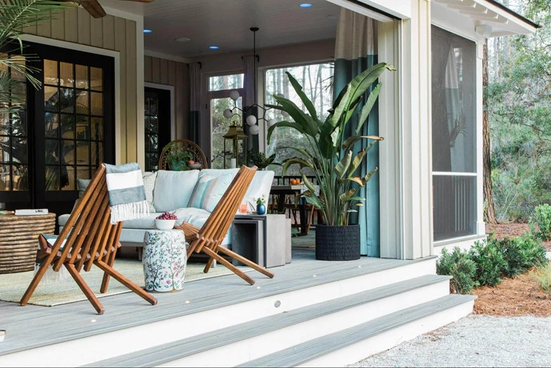 Patio with wooden chairs plants and grey box stairs