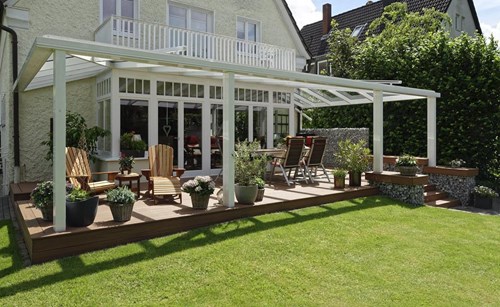 A deck partially obscured by hedges and shrubs