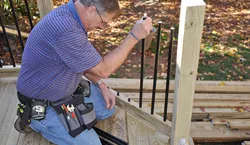 Attaching the aluminum balusters.