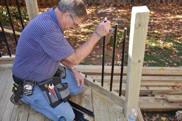 Attaching the aluminum balusters.