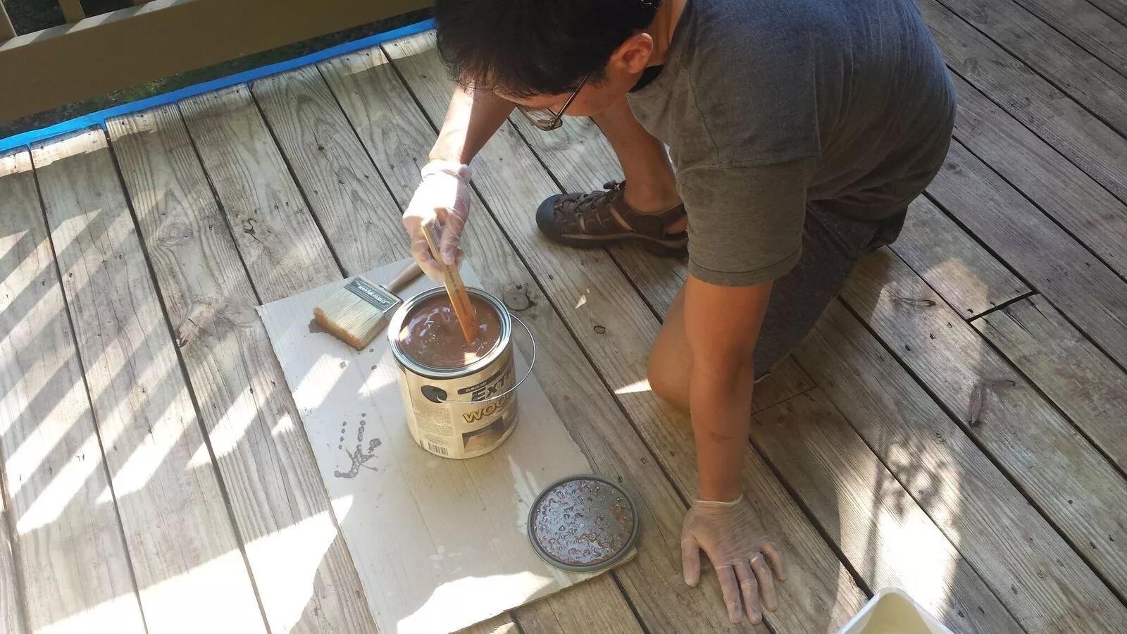 Mixing your wood stain with a stir stick.