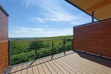 Patio with a privacy fence overlooking a grassy field