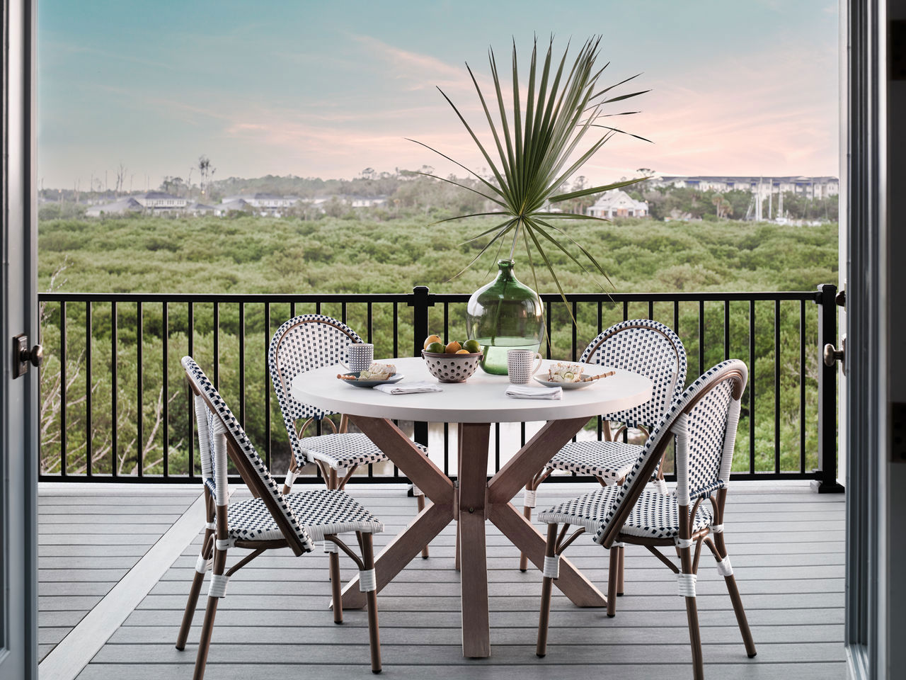 Aluminum railing on a composite deck overlooking a forest.