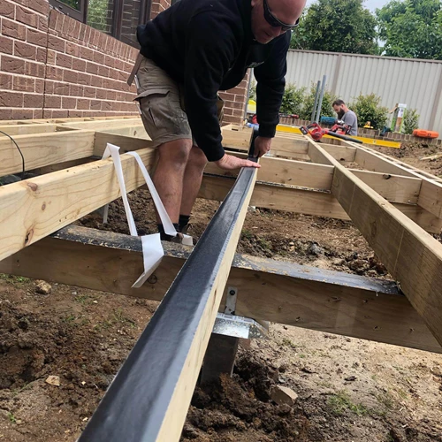 Person Applying Joist Tape