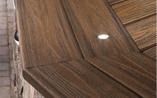 A Close Up View Of Dark Brown Patio Steps With Embedded Lights Illuminating The Deck Boards