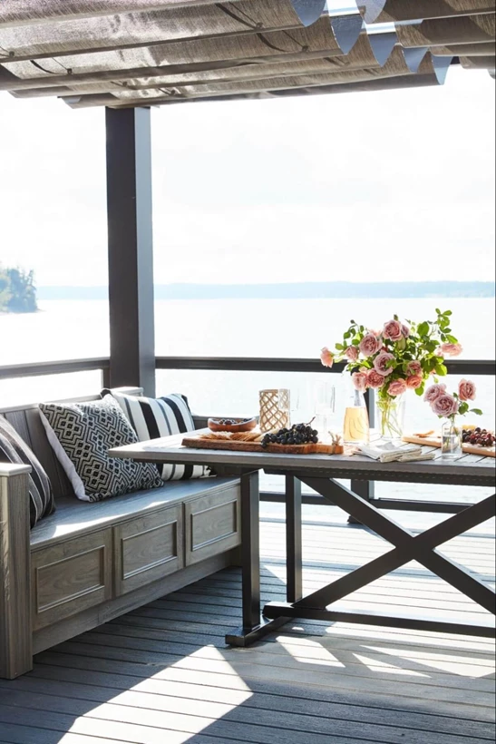 Patio on the beach shaded by a pergola